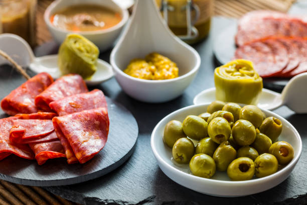 assortment of tapas and antipasti on black background. charcuterie boards of assorted appetizers. - italian cuisine wine food pasta imagens e fotografias de stock