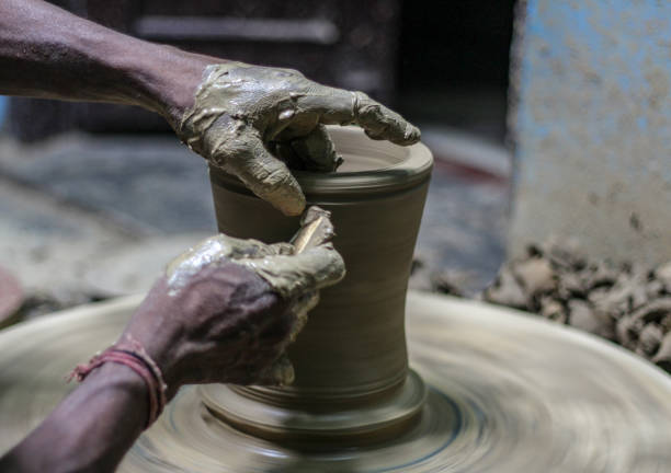 istock Close up of hands making a pot with mud 1248537305