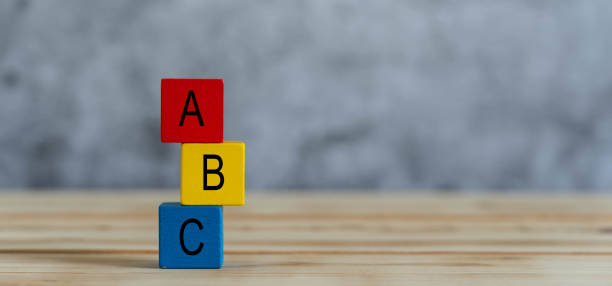close up of colorful a b c  letters alphabet on cube blocks on wooden background .business concept for choose backup plan or children kids toy for play or learning of preschool. copy space for text. - beginnings letter b planning letter a imagens e fotografias de stock