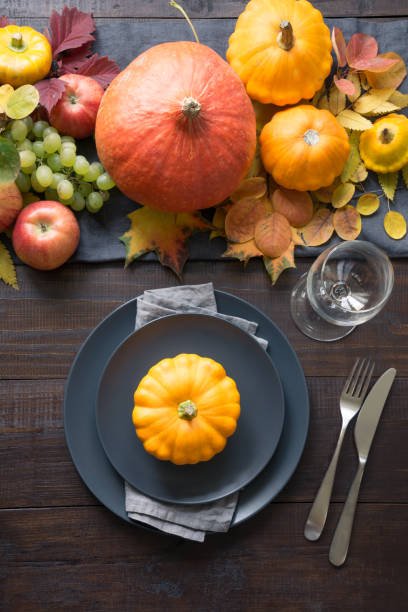 istock Fall table place setting with orange leaves and pumpkins. Vertical. Thanksgiving Day. View from above. 1248537345