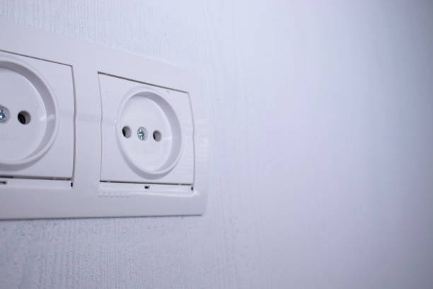 istock Sockets for electrical appliances on a light gray wall. a multifunction outlet 1248537499