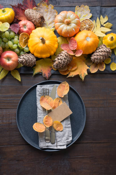 istock Fall table place setting with orange dry leaves and pumpkins. 1248537541