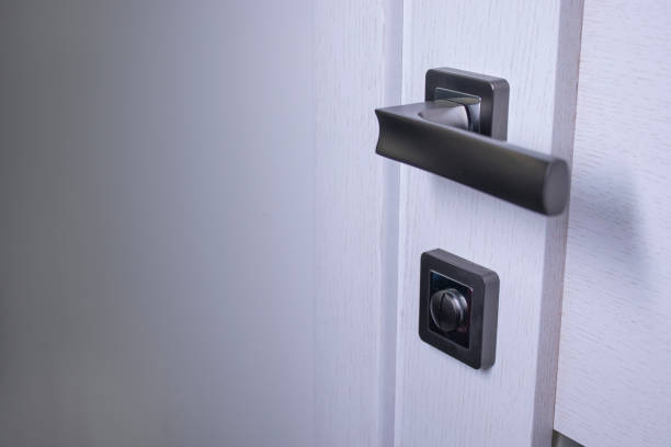 istock Door handle in the interior. Knob close-up elements. light wooden doors in in modern style in the interior 1248537598