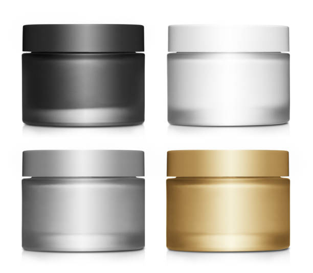 Collection of cosmetic cream jars on white