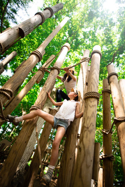 istock Mother and daughter playing in forest park 1248542658