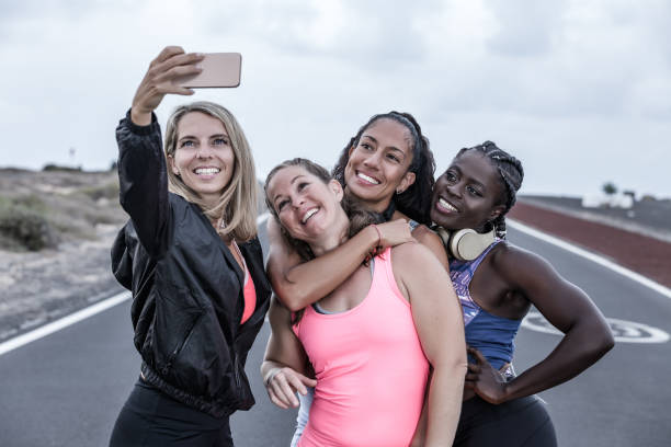 istock Delighted diverse sportswomen taking selfie during workout 1248543875