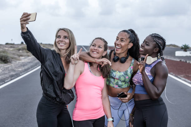istock Positive diverse female athletes gesticulating and taking selfie 1248543899