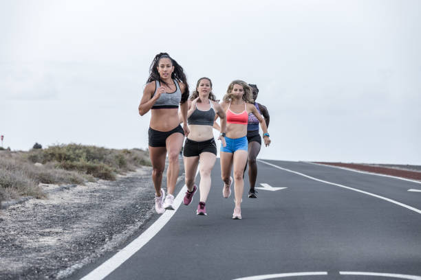 istock Diverse female friends running one after another 1248543927