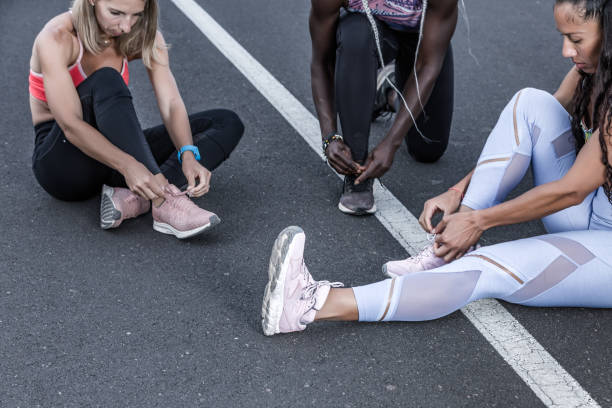 istock Crop multiethnic friends tying laces before training 1248543949