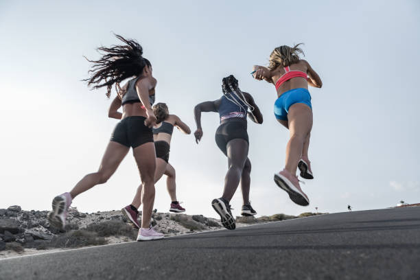 istock Unrecognizable diverse women running against evening sky 1248543977