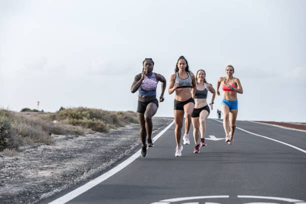 istock Determined multiethnic sportswomen running together 1248544012