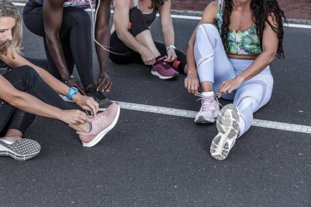 istock Crop diverse sportswomen tying laces 1248544030