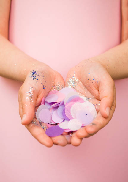 istock A child is holding colorful glitter and confetti. 1248544377