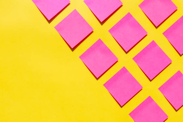 Pink sticky notes on yellow background Pink sticky notes on yellow background knolling concept stock pictures, royalty-free photos & images