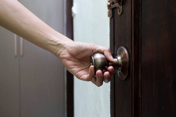 istock hand hold handle of door, close up 1248546025