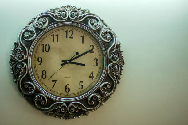 istock Ancient Wall Designer Wall Clock With Light Yellow Back Ground showing time 03.10 o'clock 1248546346