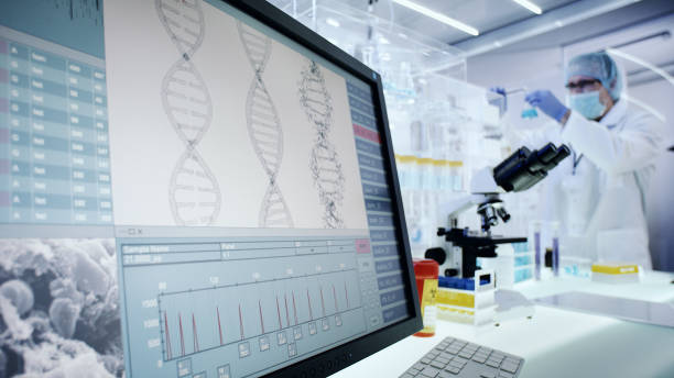 Man working on laboratory equipment. DNA research on computer screens Modern laboratory interior. Genetic Research Laboratory genetic screening stock pictures, royalty-free photos & images