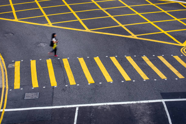 Young Chinese woman crossing the street  motion blur\nHong Kong, China