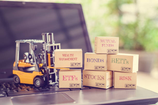 istock Boxes of financial products e.g REITs, bonds, commodities, mutual funds, stocks, ETFs on a laptop 1248549607