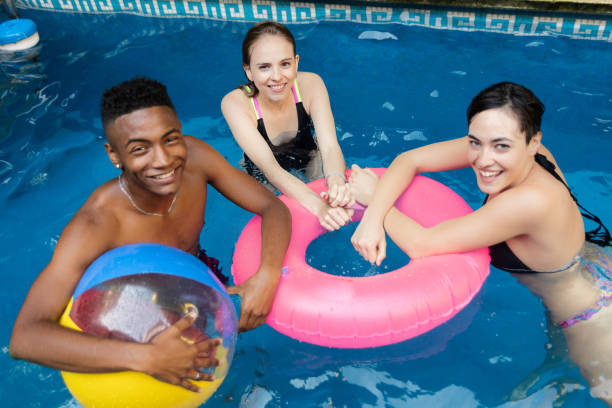 istock Group of friends having fun inside the swimming pool 1248551599