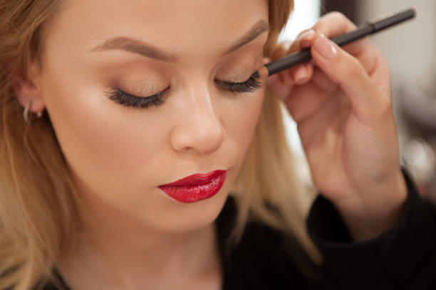 A close up of a female face wearing cosmetics.