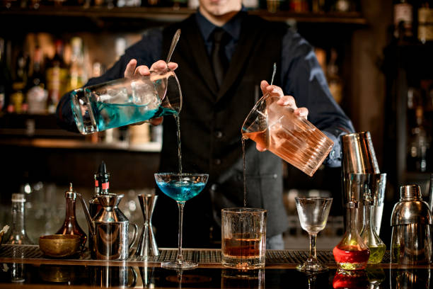 istock young bartender professionally pours cocktails into glasses. 1248552105