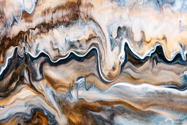 istock Fluid art texture. Background with abstract swirling paint effect. Liquid acrylic picture with flows and splashes. Mixed paints for website background. Brown, golden and navy blue overflowing colors. 1248557037