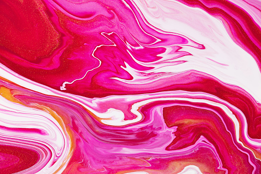 Fluid art texture. Abstract backdrop with swirling paint effect. Liquid acrylic artwork that flows and splashes. Mixed paints for background or poster. Golden, white and red overflowing colors