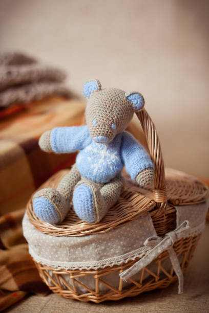 istock knitted toy bear or mouse sits on a wicker basket 1248558396