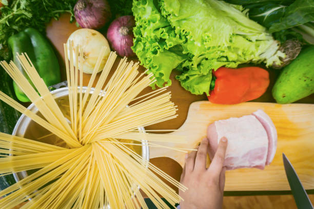 istock Preparing a delicious meal with pork, vegetables and pasta 1248558801