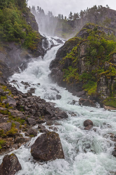 istock Waterfall on the mountain river in the rocky gorge 1248560509