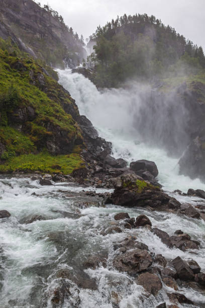 istock Waterfall on the mountain river in the rocky gorge 1248560516