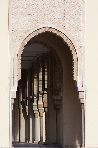 Arches of Hassan II Mosque in Casablanca on the blue cloudless sky