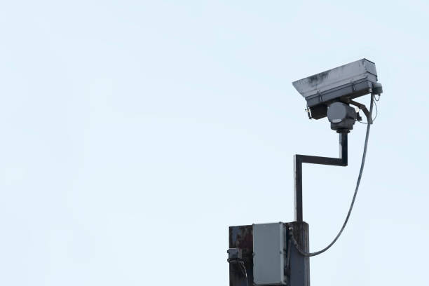 istock CCTV camera in sky watching people on street 1248561445