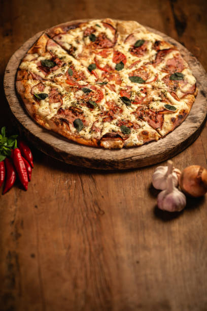 istock Delicious pizza in wood table 1248561741