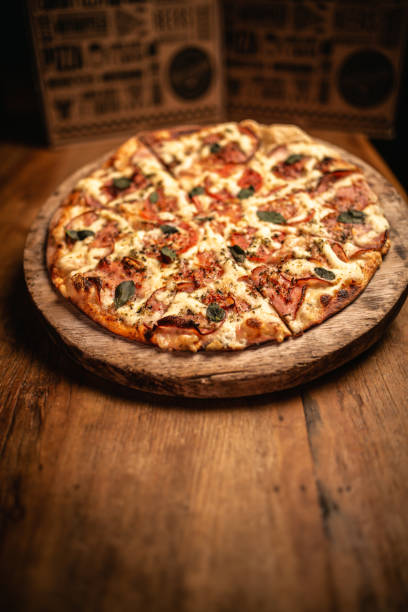 istock Delicious pizza in wood table 1248561899
