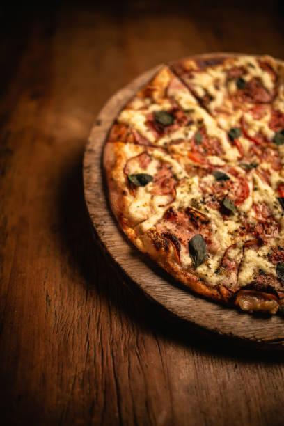istock Delicious pizza in wood table 1248561910