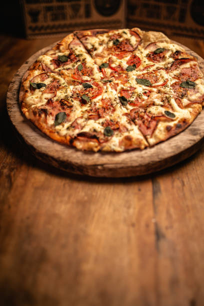 istock Delicious pizza in wood table 1248561918