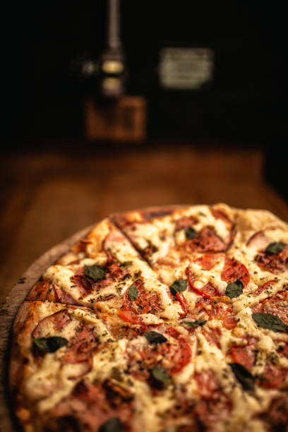 istock Delicious pizza in wood table 1248561919