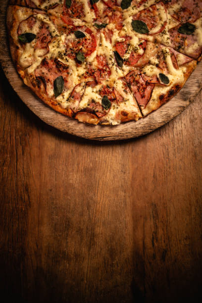 istock Delicious pizza in wood table 1248561940