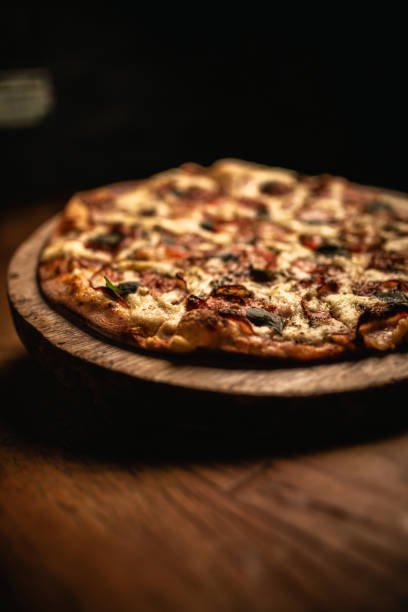 istock Delicious pizza in wood table 1248562383