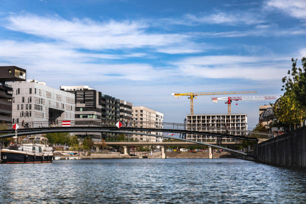 istock Confluence district with small harbor in Lyon French city and some cranes constructing new modern buildings 1248562858