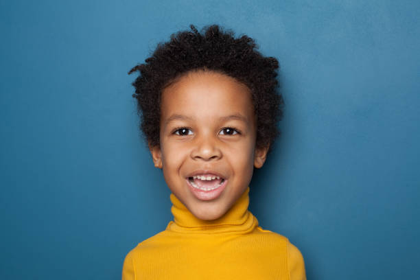 istock Surprised black kid boy on blue background 1248564389
