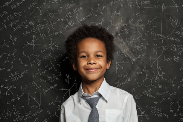 istock Happy smart black child student on blackboard background with science and maths formulas 1248564400