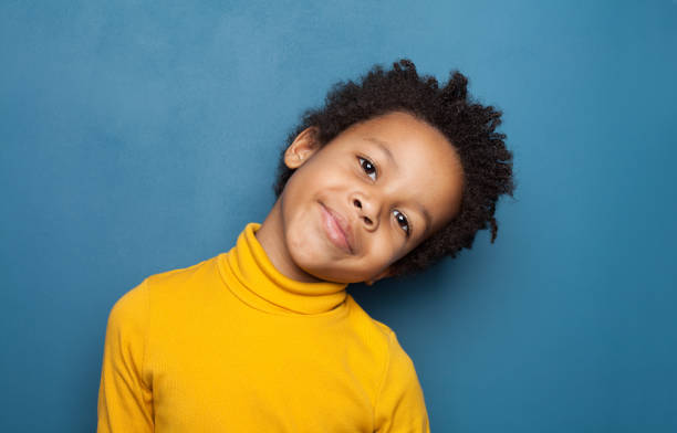 istock Curious black child boy smiling on blue background 1248564414