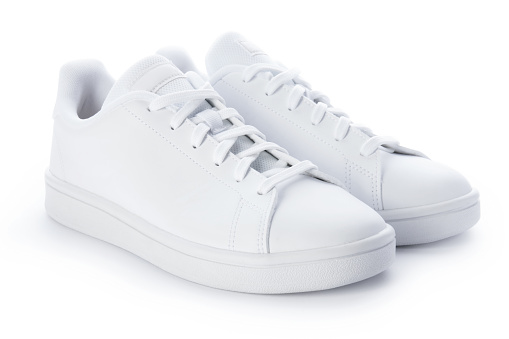 Un par de zapatillas elegantes aisladas sobre fondo blanco. Zapatos casuales blancos photo