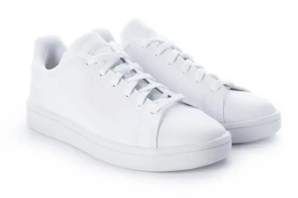 Photo of Pair of stylish sneakers isolated on white background. White casual shoes