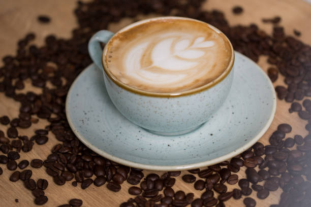 istock Close up coffee cup with heart latte art on table 1248566223