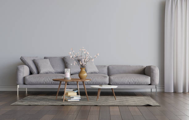 istock Living room interior with grey sofa and two coffee tables on the carpet.. Empty gray wall mockup. 3D render. 1248566368