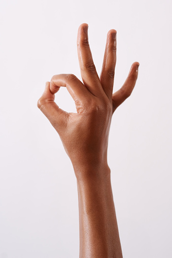 Studio shot of an unrecognizable woman making an okay gesture against a white background